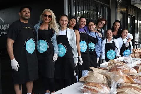 Volunteers collecting a bread donation from a local business