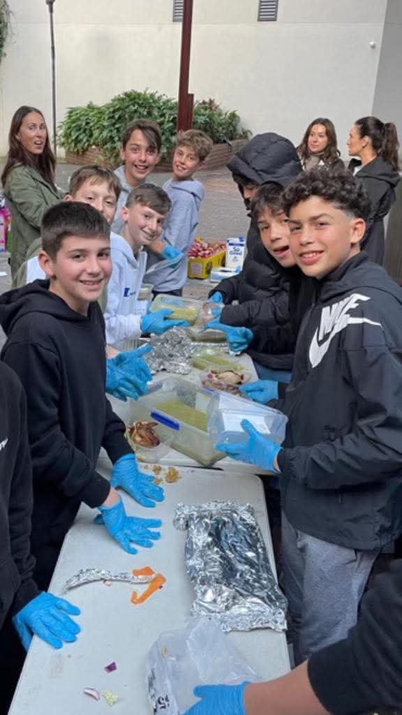 Volunteers preparing trays at a Sunday service